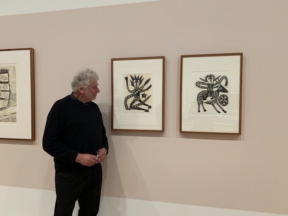 Title: Emeritus Curator Roger Butler viewing prints by Mathias Kauage in The exhibition 'Supporting the national collection: Gordon and Marilyn Darling', National Gallery of Australia, 2026.