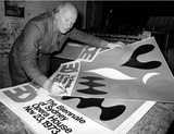 Title: John Coburn signing Biennale of Sydney Opera House poster, 1973